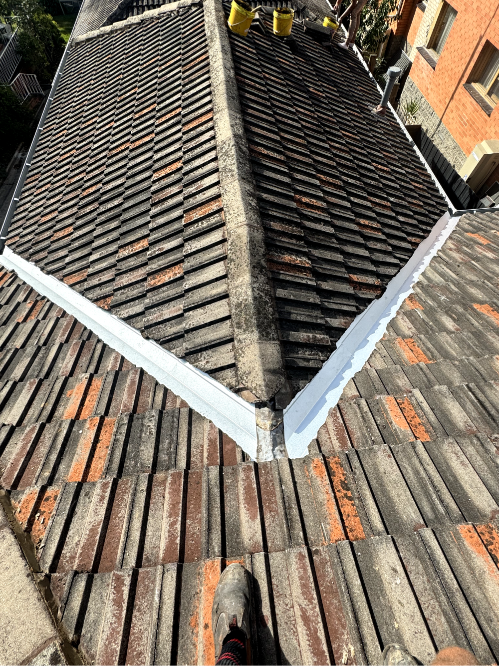 melbourne tiled roof maintenance with repointed ridge cappings to be fixed